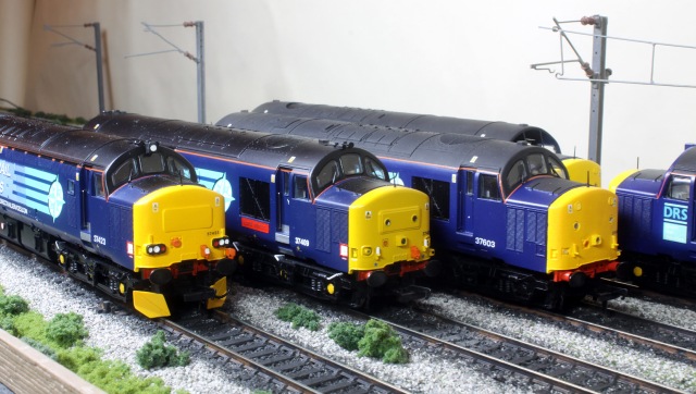 Shown here are 3 Bachmann Class 37 models, Two are the Model Rail Limited Edition, and one is a compleat repaint. Two feature PHDesigns replacement resin noses. 37423 features the correct Nose and Top Headlight, 37409 is the Std Model Rail Item and 37603 is a Std Bachmann Refurbished 37 with PHDesigns replacement noses and Lancaster City Models Waterslide DRS logo Transfers.